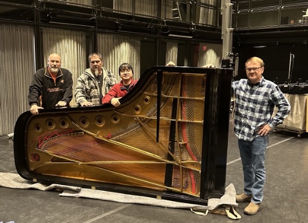 Ladd Moving team with a grand piano backstage